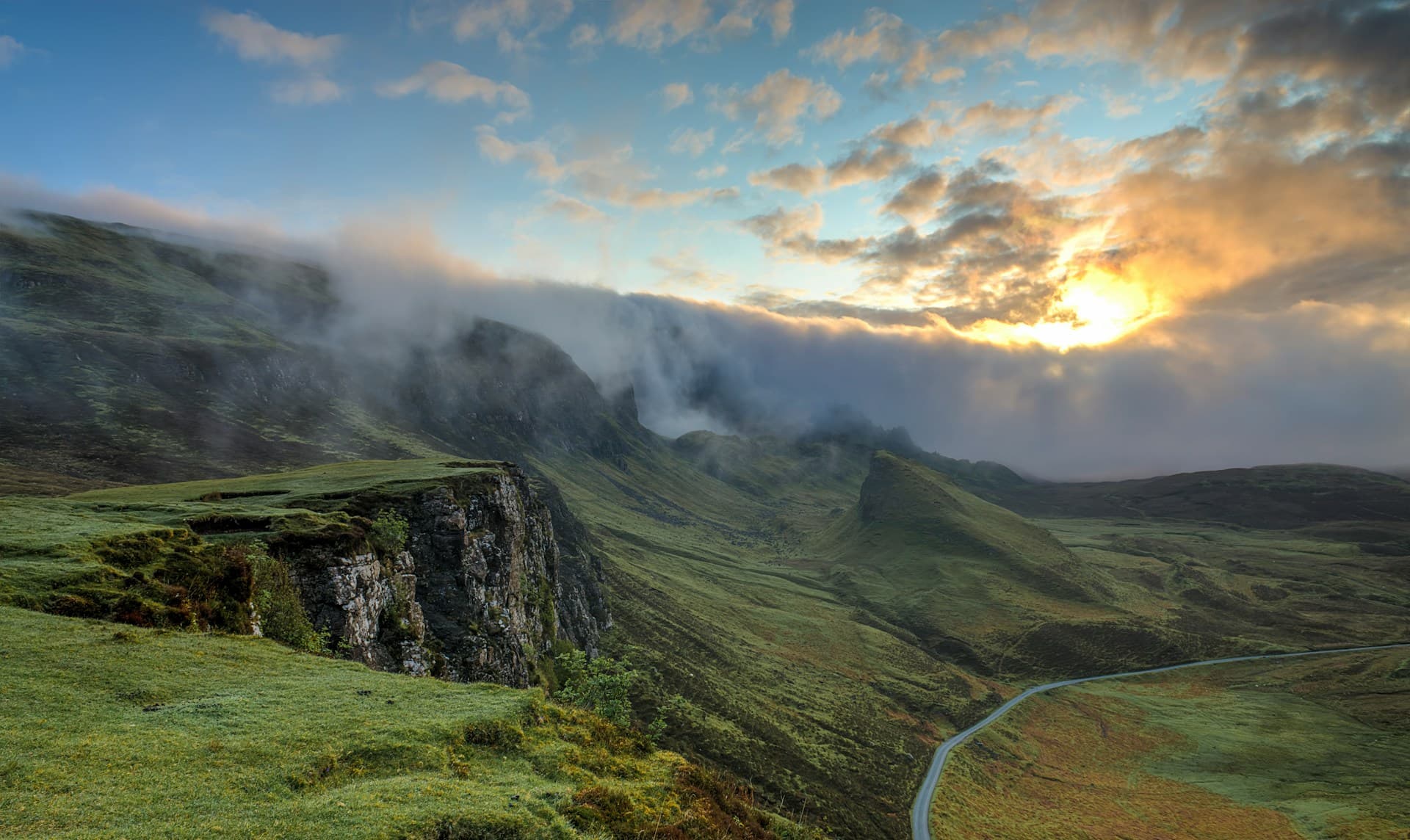 A warm rocky landscape beneath a dramatic sky